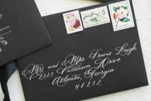 white calligraphy on black envelopes