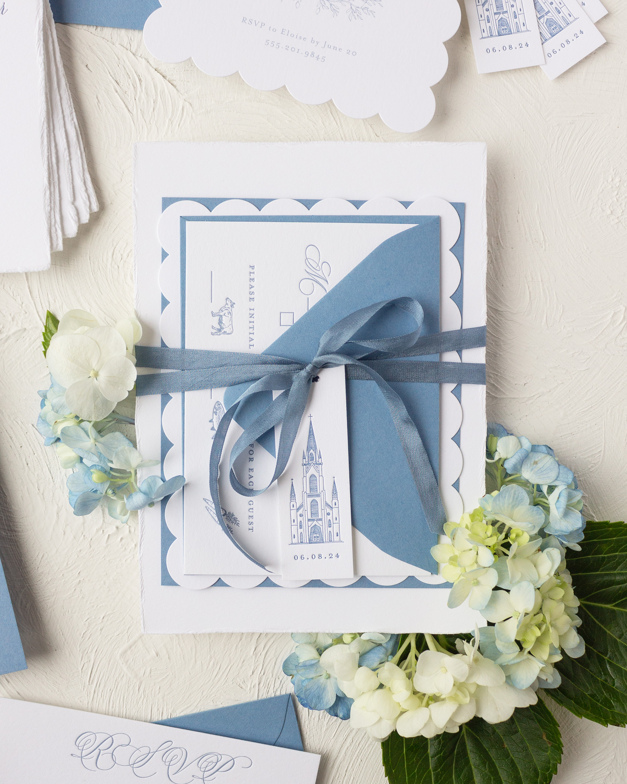 hydrangea blue wedding invitation with ribbon and tag