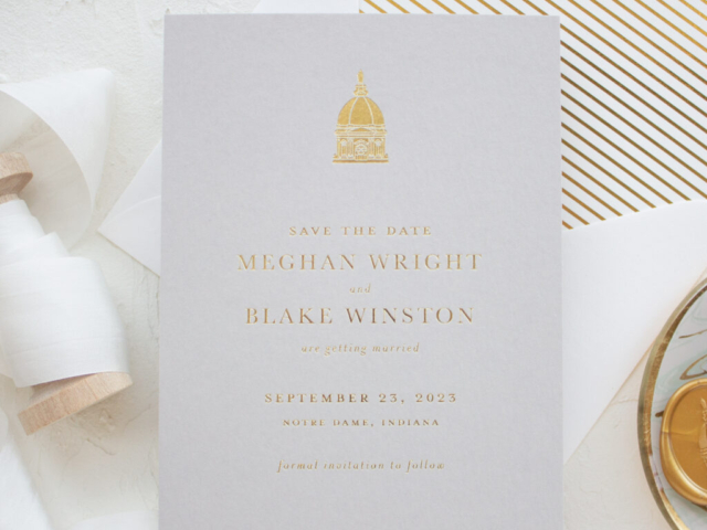 save the date card in gold foil with venue illustration of Notre Dame