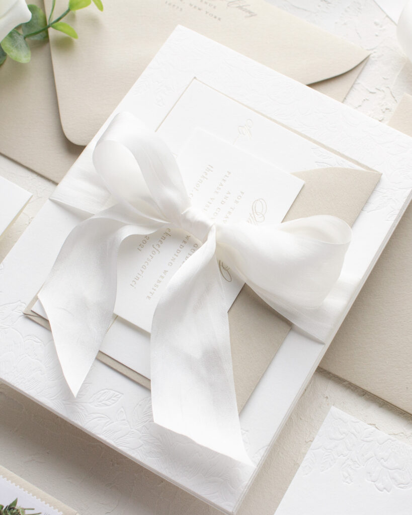 wedding invitation with silk ribbon tied in a bow