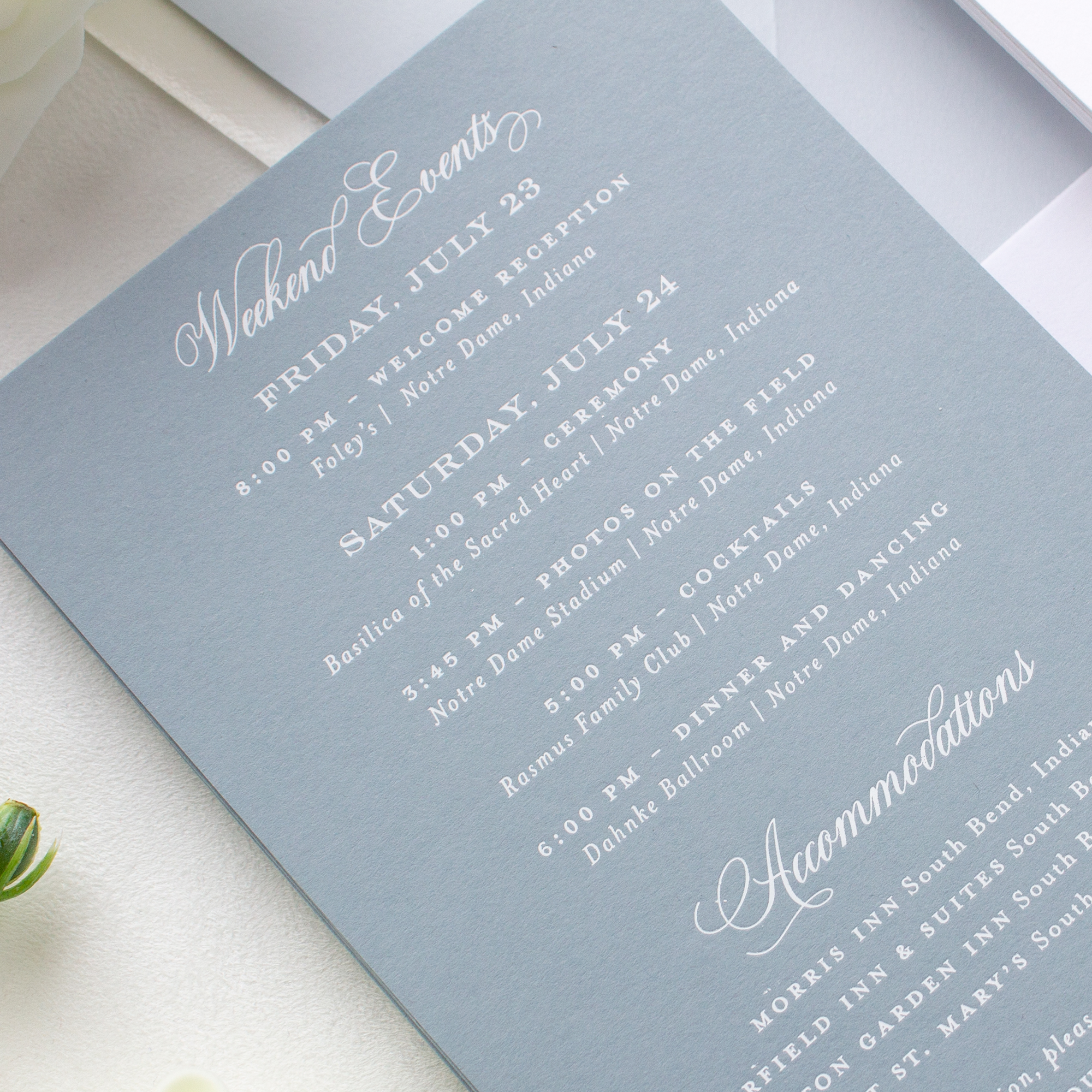 white foil on dusty blue wedding invitation
